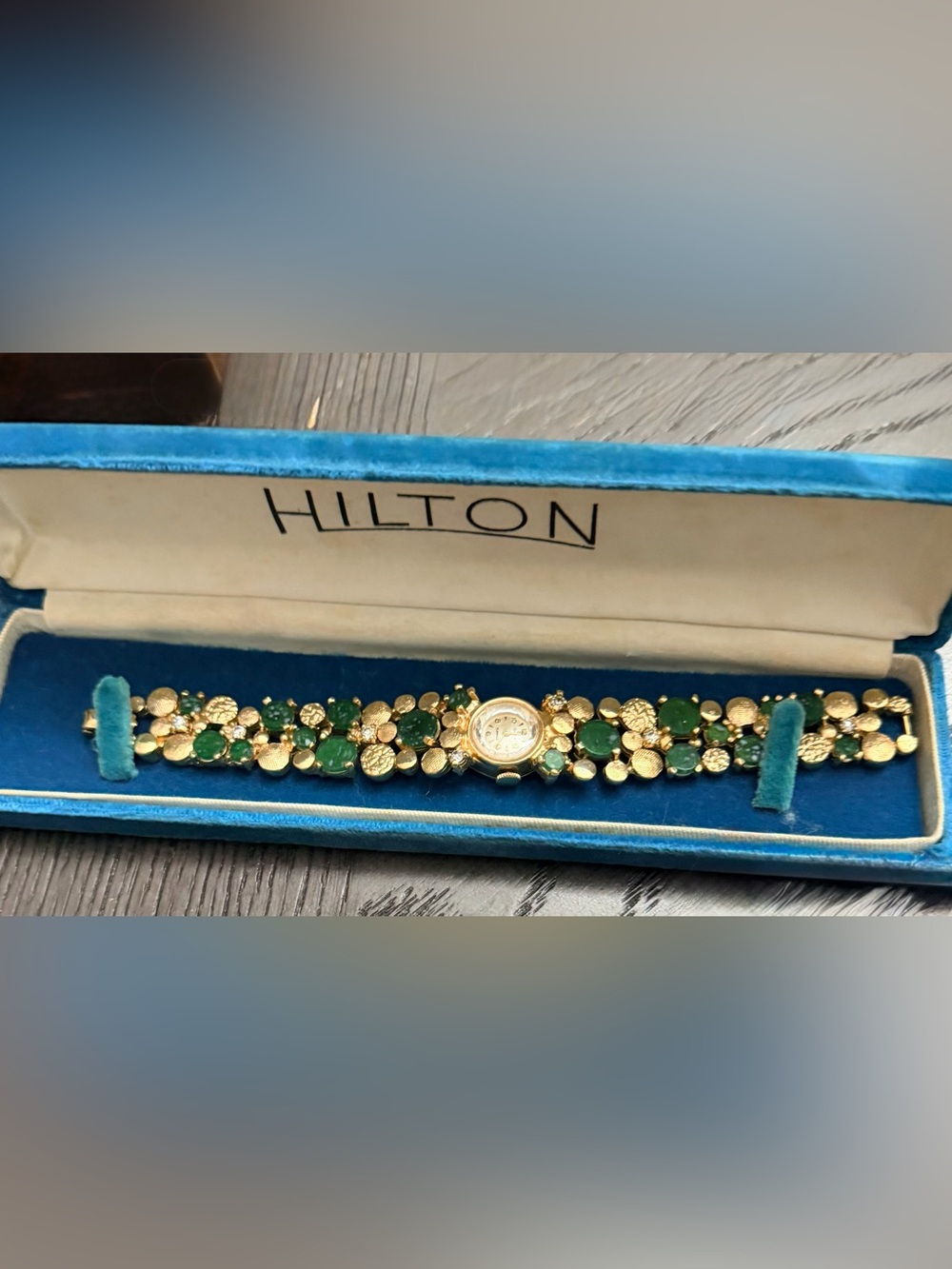 Vintage HILTON Gold Tone Bracelet Watch with Emerald Green Stones